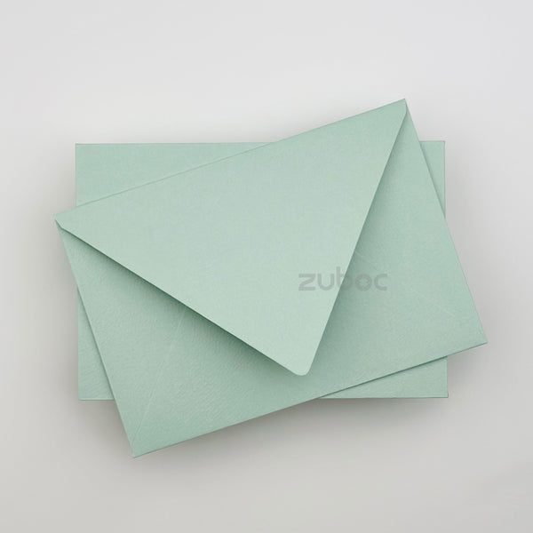 Soft mint green envelope C6 top-down view for art projects