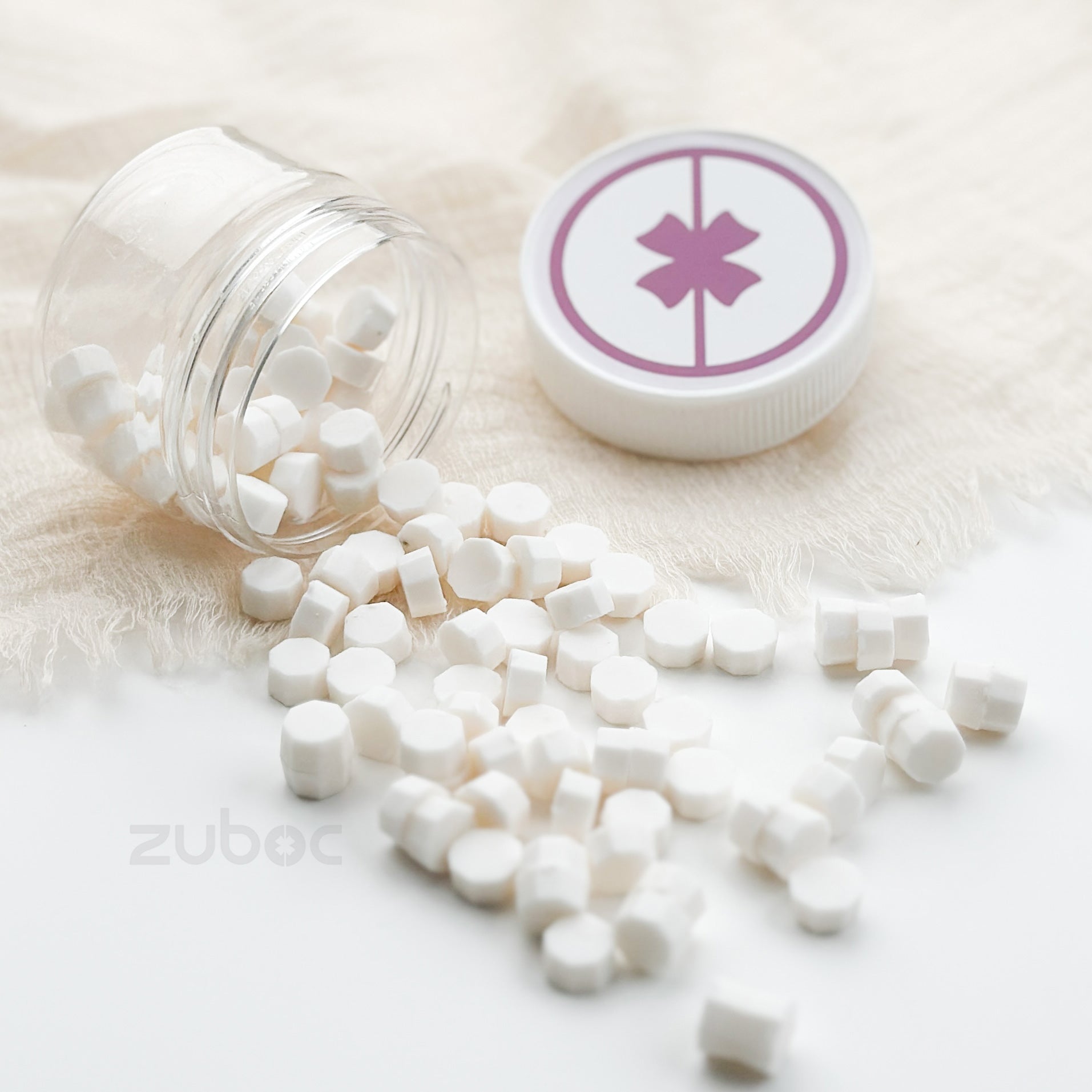 Clear container with white capsules and a cap featuring a star symbol on a light background.