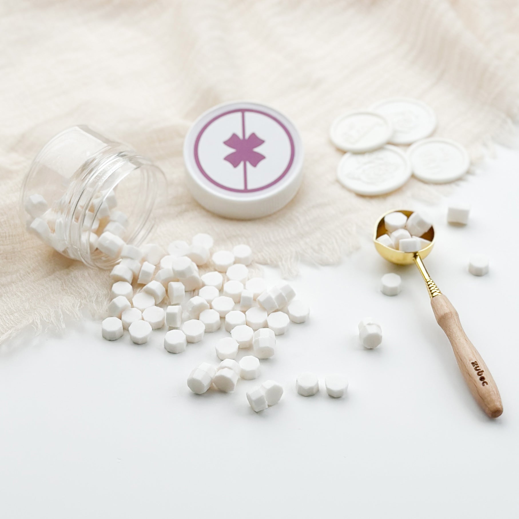 White pills spilling out of a jar with a pink star symbol on a light background