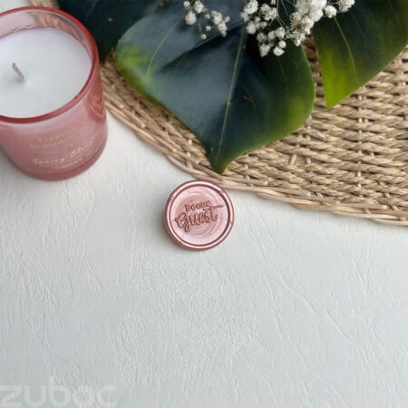 Rose gold round Be Our Guest Wax Seal on white background