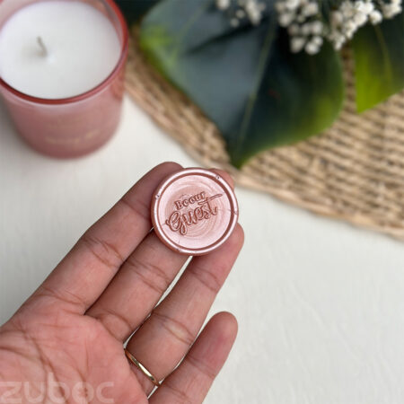 Rose gold round Be Our Guest Wax Seal on white background