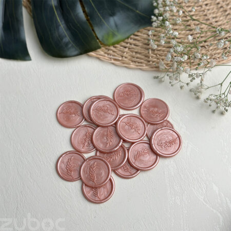 Wax seal with a rose gold branch design on ideal envelopes