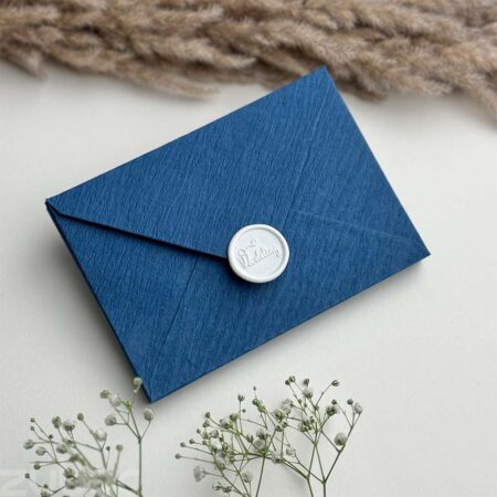 Crinkled teal std envelope and snow white wedding wax seal