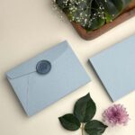 Elegant wedding invitation envelope light blue with cherry blossom wax seal-