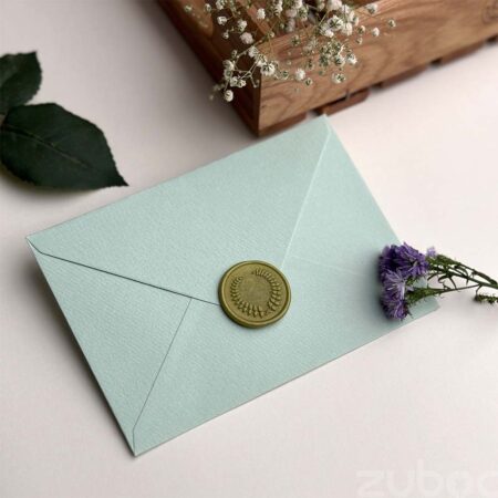 Stylish light aqua envelope and olive green wax seal