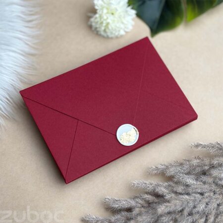 Maroon counterflap envelope with a gold foil wax seal for elegant presentations.