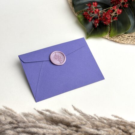 Purple wedding invitation envelope with lilac lily wax seal