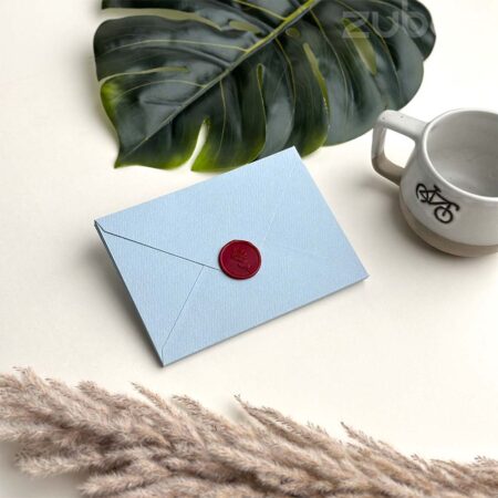 Light blue std envelope with wine red rose stem wax seal