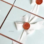 Aqua Whisper Elegance Wedding Invitation set with insert card, wax seal, and ribbon